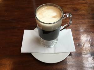 Gaelic Coffee: sweet coffee with Irish whiskey on a wooden table