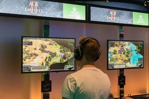 Games fair visitor plays the popular strategy game Age of Empires II: Definitive Edition on Xbox