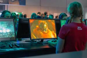 Games fair visitors play the Remake of Final Fantasy VII at Gamescom in Germany