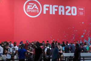 Gamescom visitors wait in line to play the soccer simulation game Fifa 20 by EA Sports