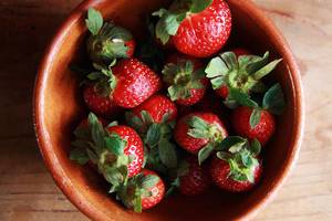 Garden harvest: top view of ripe strawberries in a ceramic bowl