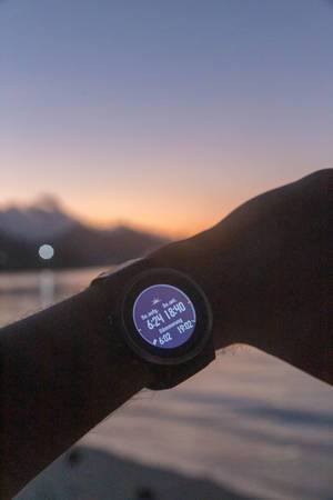 Garmin Fenix 5S Smart watch shows sunset, sunrise and twilight hours at Constance Ephelia Resort in Mahé, Seychelles, in front of blurry Indian Ocean