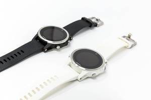 Garmin Fenix 5S Smartwatches in black and white on white background