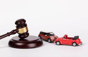 Gavel and two toy cars