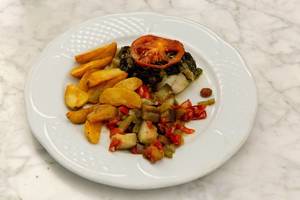 Gegrillter Schwertfisch mit einer Tomatenscheibe,  Kartoffelecken und Gemüse