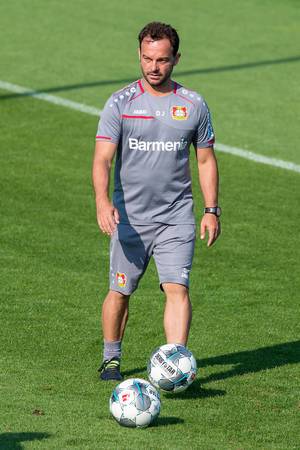 German Athletics coach Daniel Jouvin in grey jersey with soccer balls during soccer training of Bayer 04 Leverkusen