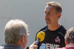 German radio station interviews soccer coach Achim Beierlorzer after the training session of his cologne soccer team