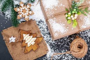 Gift in original box on snow background. The concept of preparing for the winter holidays