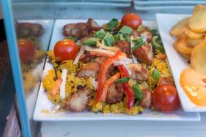 Ginger honey chicken with yellow rice, peppers and cherry tomatoes