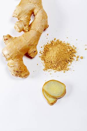 Ginger, slices and ground on white background