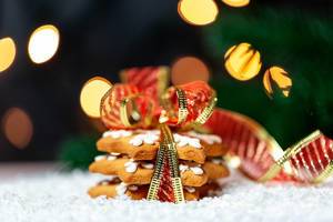 Gingerbread cookies on a background of snow and light garland