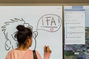 Girl writing on a large touchscreen with stylus support