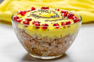 Glass bowl with finished oatmeal with pomegranate and Chia seeds