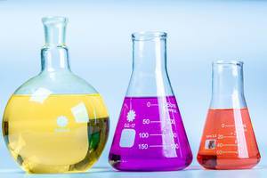Glass flasks of different shapes with colored solutions. Concept of chemical experiments