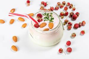 Glass jar with yogurt, strawberries and almonds. Healthy breakfast concept (Flip 2020)