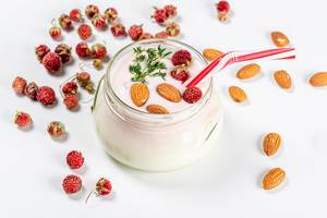 Glass jar with yogurt, strawberries and almonds. Healthy breakfast concept