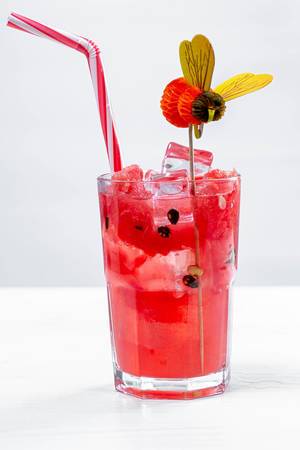 Glass of watermelon cocktail with ice cubes and straw (Flip 2019)