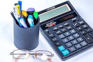 Glasses, calculator and pens