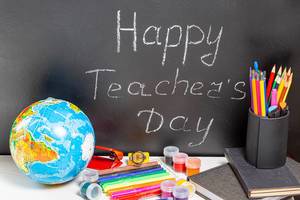 Globe and school supplies with teg Happy Teacher