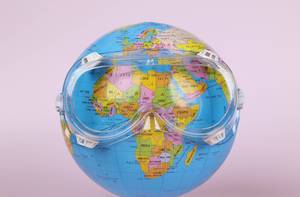 Globe wearing safety goggles