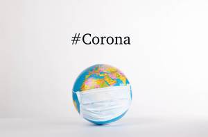 Globe with medical mask and #Corona text on white background