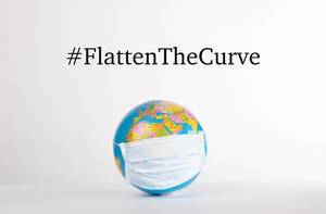 Globe with medical mask and #FlattenTheCurve text on white background