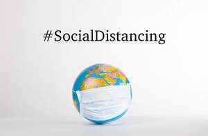 Globe with medical mask and #SocialDistancing text on white background