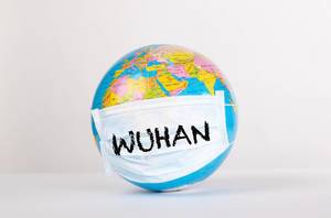 Globe with medical mask and Wuhan text
