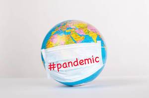 Globe with medical mask on white background with #pandemic text