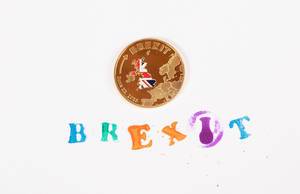 Gold Brexit medal coin with colorful Brexit stamp text