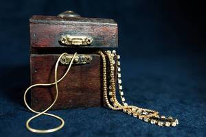 Gold chains in tiny wooden chest