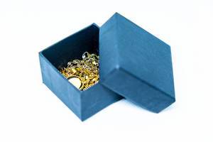 Gold jewelry in a box on white background