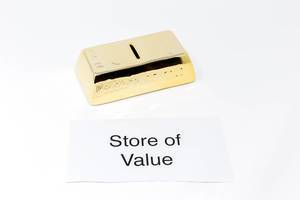 Goldbarren und Papier mit STORE OF VALUE (Wertspeicher) steht für Gold als Wertanlage