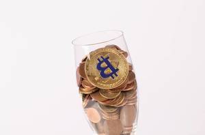 Golden Bitcoin and coins in champagne glass (Flip 2019)