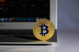Golden Bitcoin on a laptop