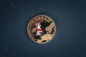 Golden Brexit medal coin on a black background