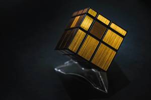 Golden cube puzzle on black background