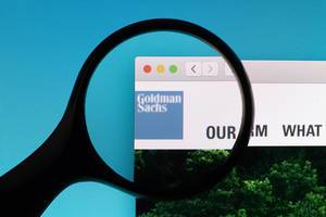 Goldman Sachs logo under magnifying glass