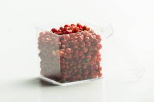 Grains of red pepper in a square transparent package