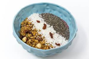 Granola nut crunchy cluster cereals with coconut flakes, chia seeds and goji berries in a bowl