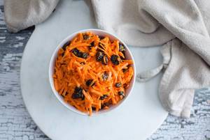 Grated Carrot Salad with Raisin in a White bowl  (Flip 2019) (Flip 2019)