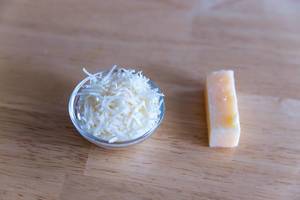 Grated cheese in small glass bowl