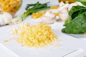 Grated cheese on a white kitchen Board (Flip 2019)