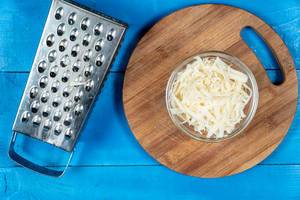 Grated Cheese on the wooden kitchen board