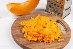 Grated Fresh Raw Pumpkin on the wooden board