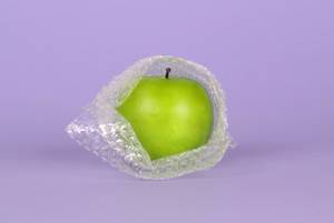 Green apple packed in bubble wrap