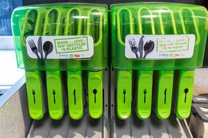 Green box with environmentally friendly and recyclable cutlery, bpa-free at American organic supermarket Whole Foods Market