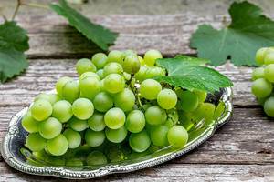 Green bunch of grape on gray wooden background (Flip 2019)