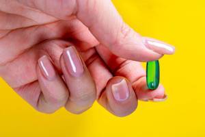Green capsule analgesic in the hand