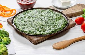 Green pizza base and fresh vegetables on white table (Flip 2019)